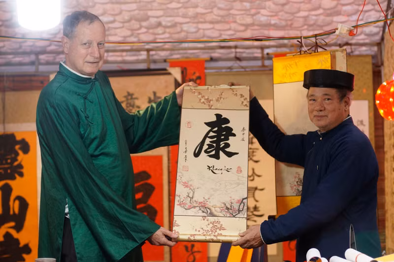 L’ambassadeur d’Israël au Vietnam, Yaron Mayer (à gauche), demande une calligraphie porte-bonheur à l’occasion du Nouvel An lunaire 2024. Photo : thoidai.