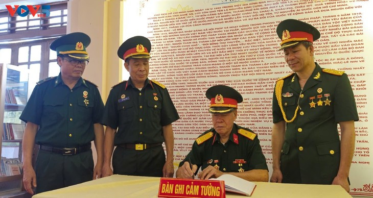 Des vétérans écrivent leurs pensées dans le livre commémoratif de l'Oncle Hô. Photo : VOV. Des vétérans écrivent leurs pensées dans le livre commémoratif de l'Oncle Hô. Photo : VOV.
