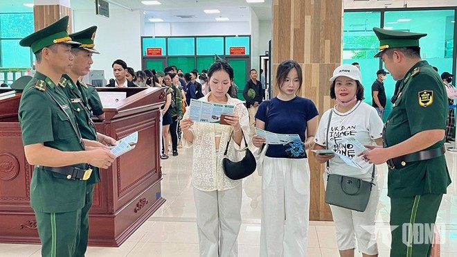 Les agents du Poste frontalier international de Lào Cai distribuent des dépliants de sensibilisation aux lois et règlements aux passagers franchissant la frontière. Photo: qdnd.vn Les agents du Poste frontalier international de Lào Cai distribuent des dépliants de sensibilisation aux lois et règlements aux passagers franchissant la frontière. Photo: qdnd.vn