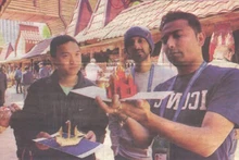 Tôn Thât Vinh (à gauche) et des touristes devant sa boutique au marché d’Izmaïlovo, à Moscou. Photo : CVN