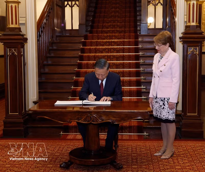 Le secrétaire général du PCV et président To Lam signe le livre d'or. Photo : VNA.