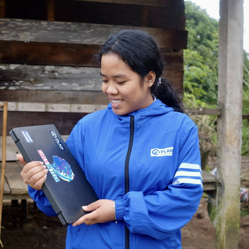 Xuc et l’ordinateur offert par Plan International Vietnam pour soutenir son apprentissage. Photo : Plan International Vietnam.