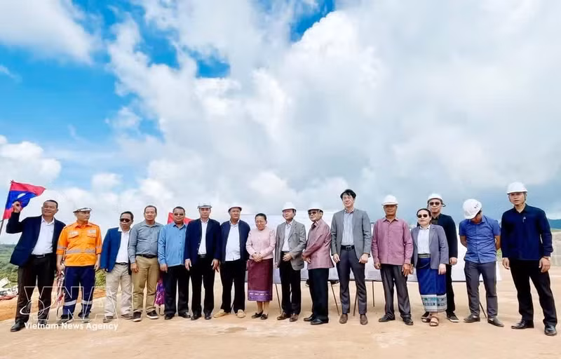 Les membres de la délégation de l’Assemblée nationale du Laos et les représentants du groupe vietnamien Viet Phuong posent sur le chantier du projet de complexe minier de bauxite et de traitement d’alumine de Dakcheung. Photo : VNA.