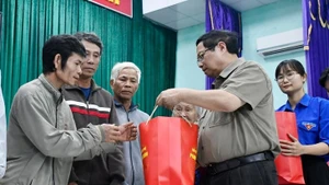 Le Premier ministre Pham Minh Chinh remet des cadeaux aux sinistrés de Hoa Thinh. Photo : VOV.