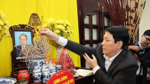 Le président Luong Cuong offre de l'encens à l'ancien chef de l'État Tran Duc Luong. Photo: VNA