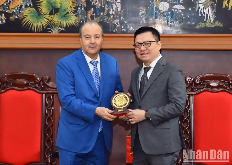 Le rédacteur en chef Lê Quôc Minh (à droite) offre à l'ambassadeur Abdelhamid Boubazine le logo du Journal Nhan Dan. Photo : NDEL.