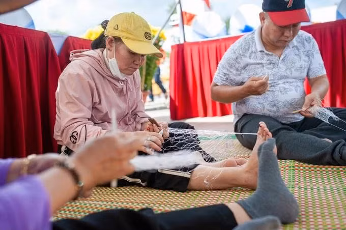 Les habitants participent à un concours de tissage de filets de pêche.