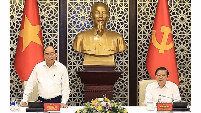 Le Président du Vietnam, Nguyên Xuân Phuc (à gauche), travaille avec la Direction chargée de la rédaction de la Stratégie d’édification de l’État de droit socialiste au Vietnam jusqu’en 2030, avec vision pour 2045. Photo : VNA.